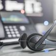 Communication support, call center and customer service help desk. VOIP headset on laptop computer keyboard.