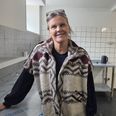 Karen Kjærgaard med hånden på dey nye inventar i køkkenet. I butikken ved siden af er John Andersen i gang med at male en væg i den for Karens Køkken karakteristiske røde farve. Foto: Anette Bonde.