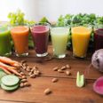healthy eating, drinks, diet and detox concept - glasses with different fruit or vegetable juices and food on table