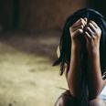 Little sad girl hiding or locked in the basement. trafficked and abused